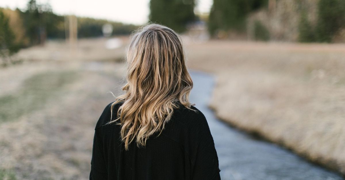 Woman meditating on a walk.