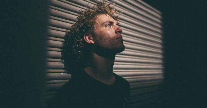 Man Leaning Up Against a Wall with a Solemn Expression; How can we walk out our purpose during hard seasons of life?