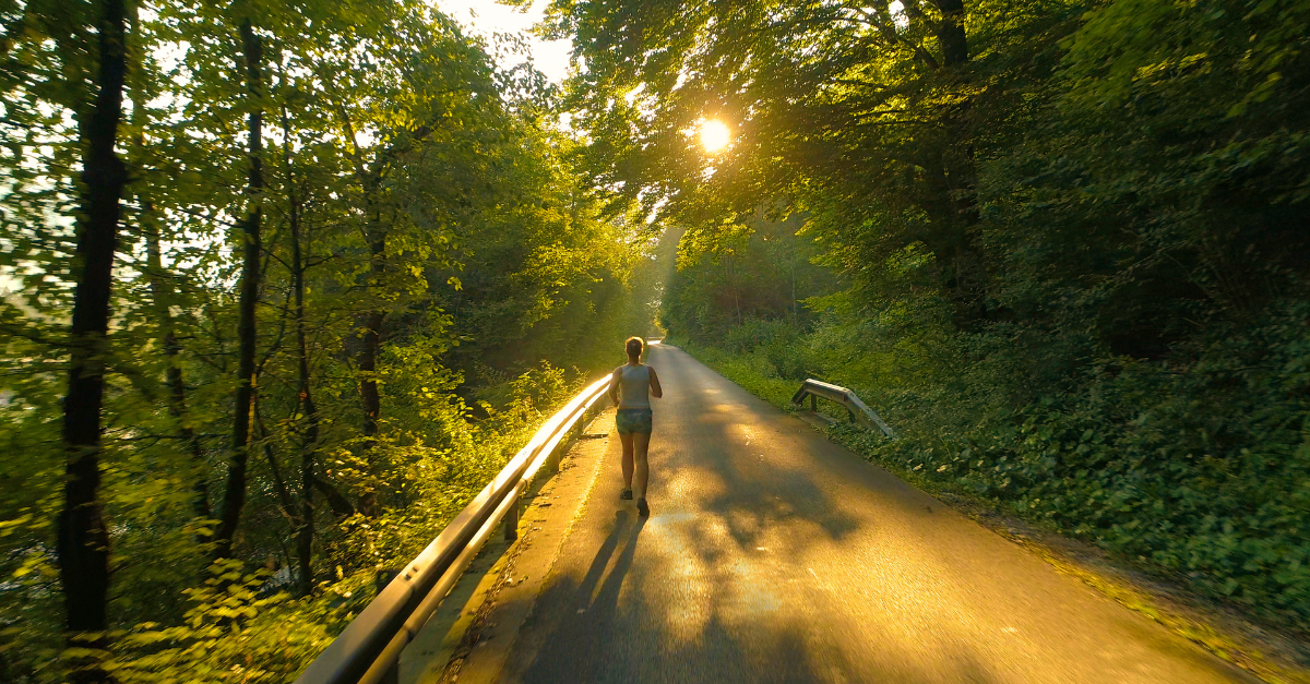 Runner on empty road at sunrise